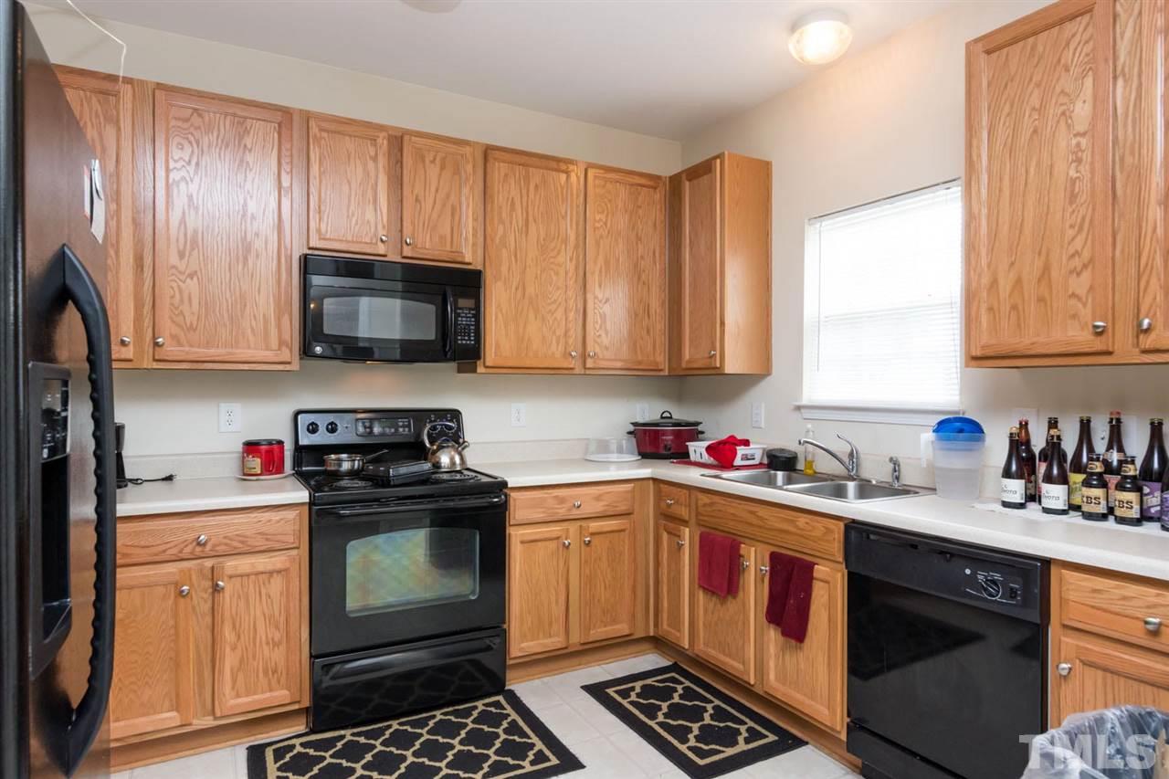 3515 Oneonta Avenue Raleigh, NC 27604 - Photo 5 of 13 a kitchen with a sink stove top oven and cabinets