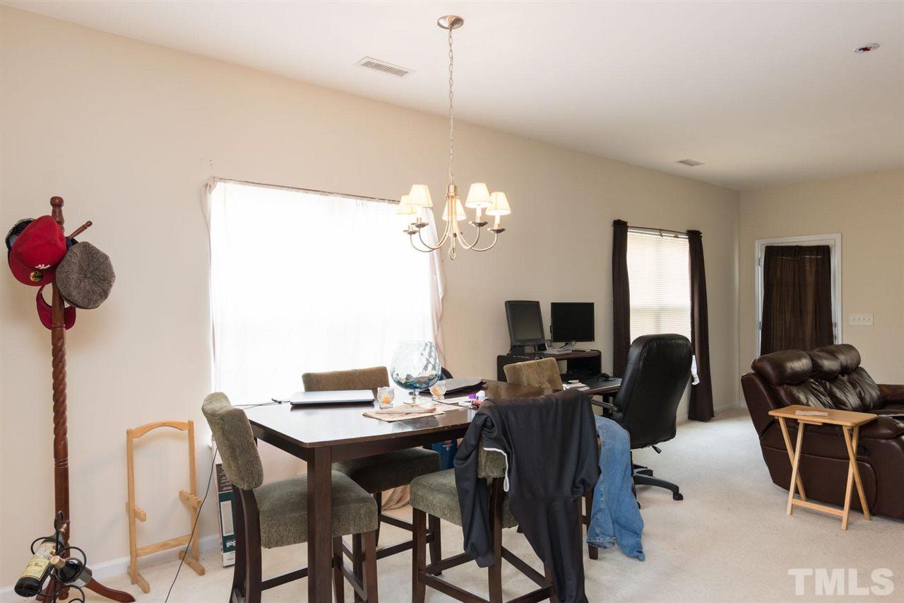 3515 Oneonta Avenue Raleigh, NC 27604 - Photo 7 of 13 a view of a dining room with furniture and chandelier