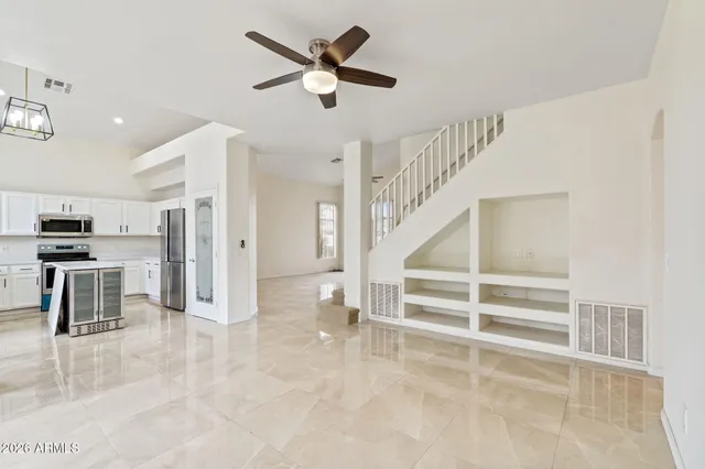 a view of a livingroom with a ceiling fan and window