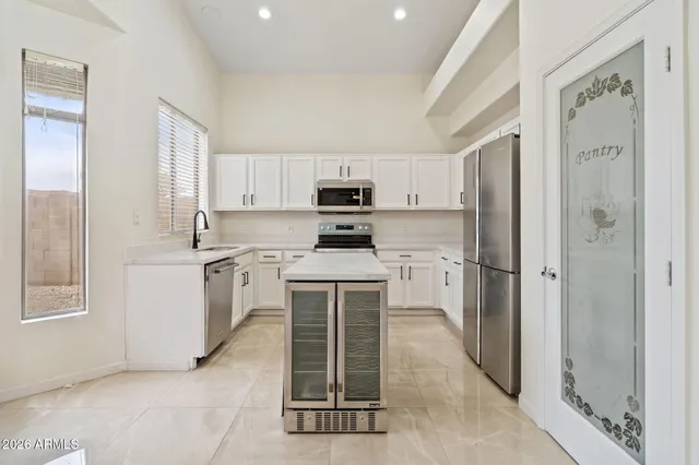 a kitchen with stainless steel appliances a sink stove and cabinets