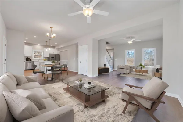 a living room with furniture and kitchen view
