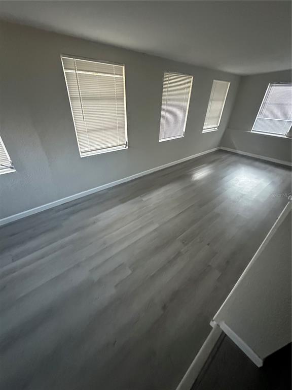 2435 North Junglecamp Road Inverness, FL 34453 - Photo 12 of 13 an empty room with wooden floor and windows