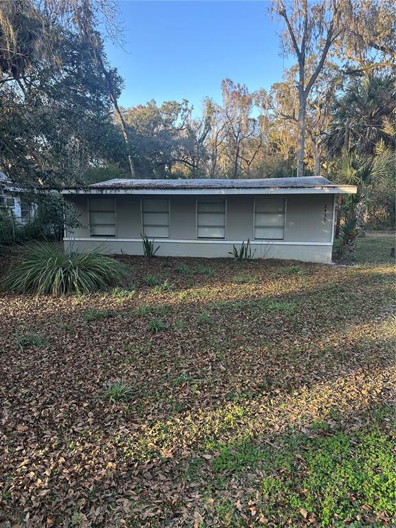2435 North Junglecamp Road Inverness, FL 34453 - Photo 2 of 13 a view of a wooden house with a yard