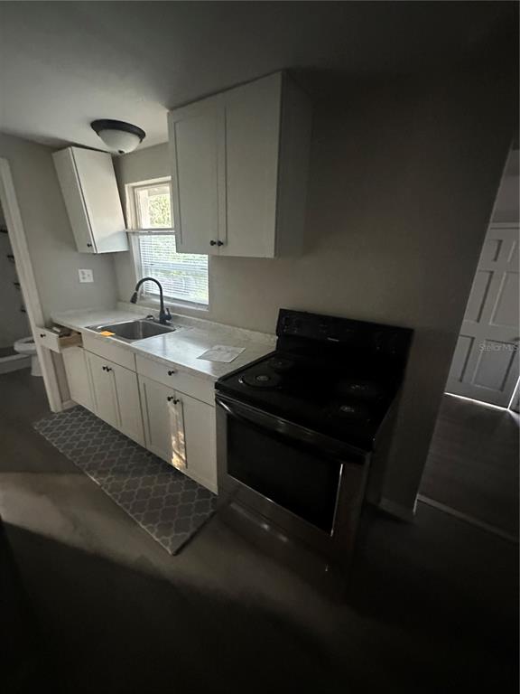 2435 North Junglecamp Road Inverness, FL 34453 - Photo 8 of 13 a kitchen with a sink stove and cabinets