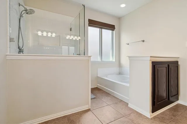 a bathroom with a bathtub and a shower