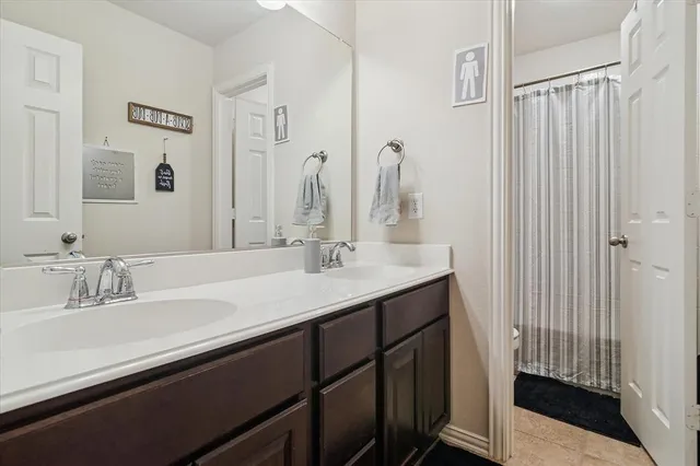 a bathroom with a double vanity sink and a mirror