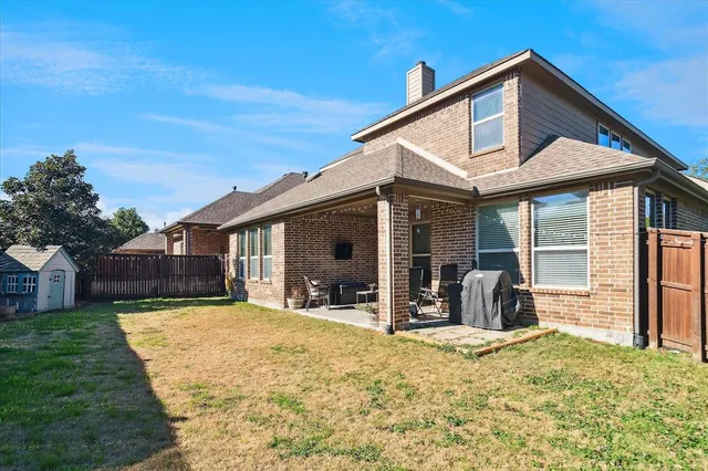 a view of a house with a yard and sitting area