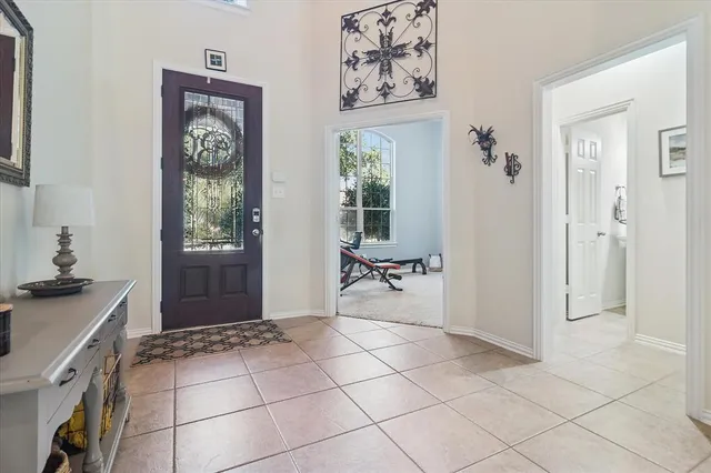 a view of a hallway with workspace and a window