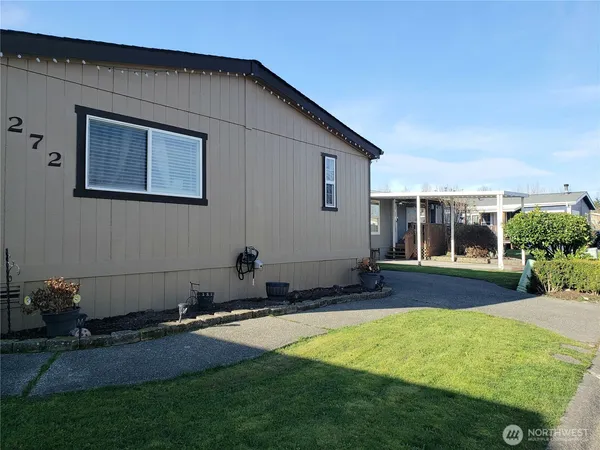 a backyard of a house with yard and garage