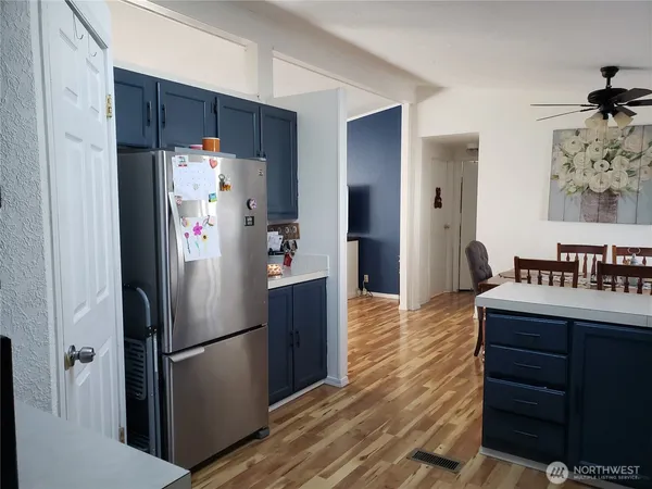 a kitchen with stainless steel appliances a refrigerator and a dining table