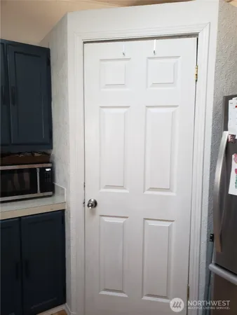 a view of a dining room with furniture a rug and wooden floor