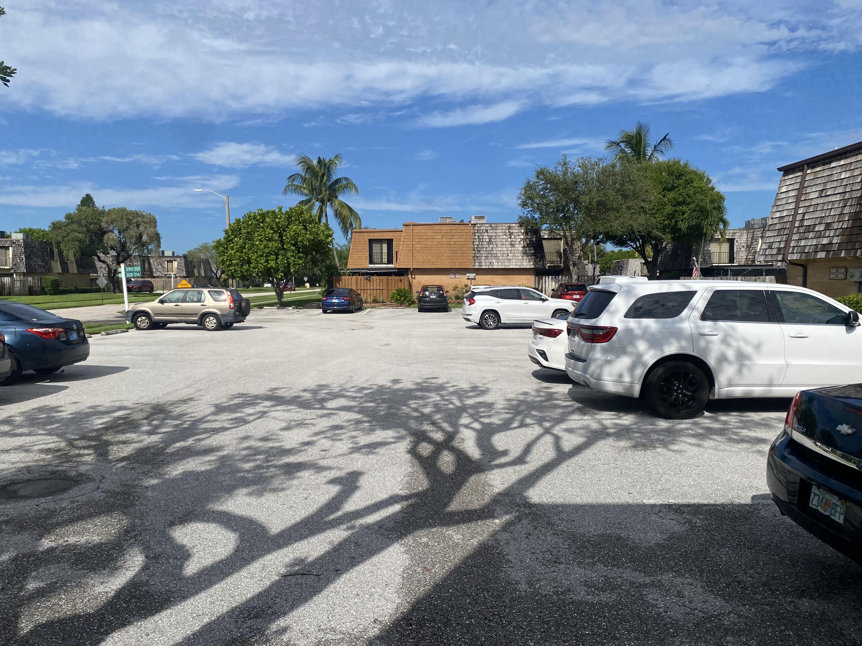 a view of a cars park in front of a building