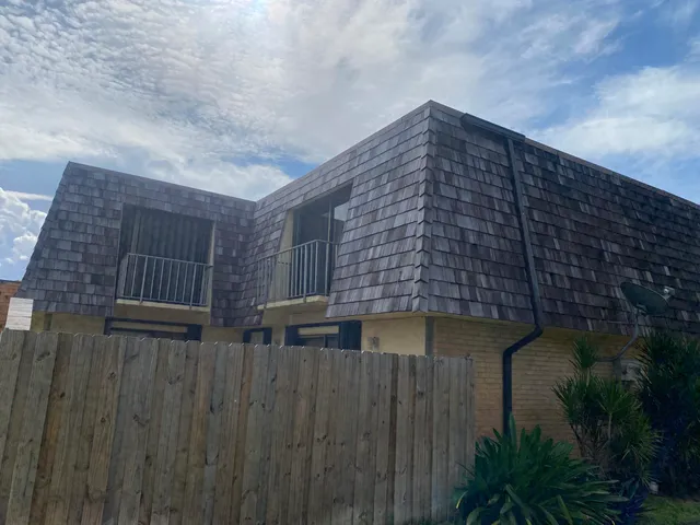 a tall building with a trees in front of it