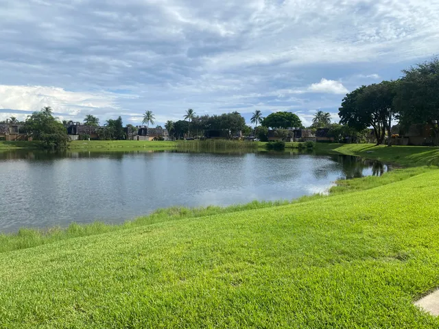 an aerial view of a house with garden space and lake view