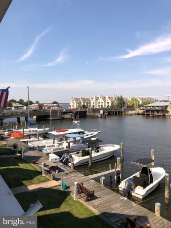 a view of a ocean with boats and trees in the back