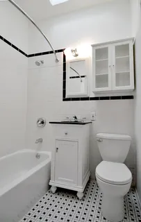 a bathroom with a granite countertop toilet a sink and a bathtub