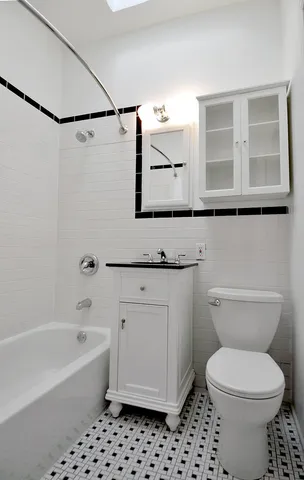 a bathroom with a granite countertop toilet a sink and a bathtub