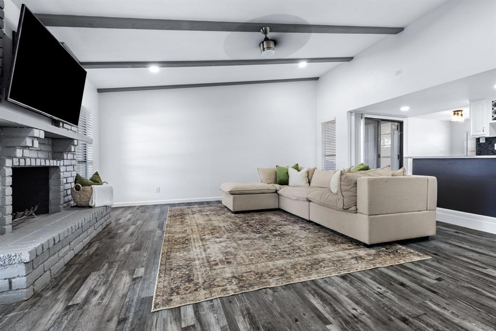 3429 Post Oak Road Garland, TX 75044 - Photo 11 of 36 a living room with furniture and a fireplace