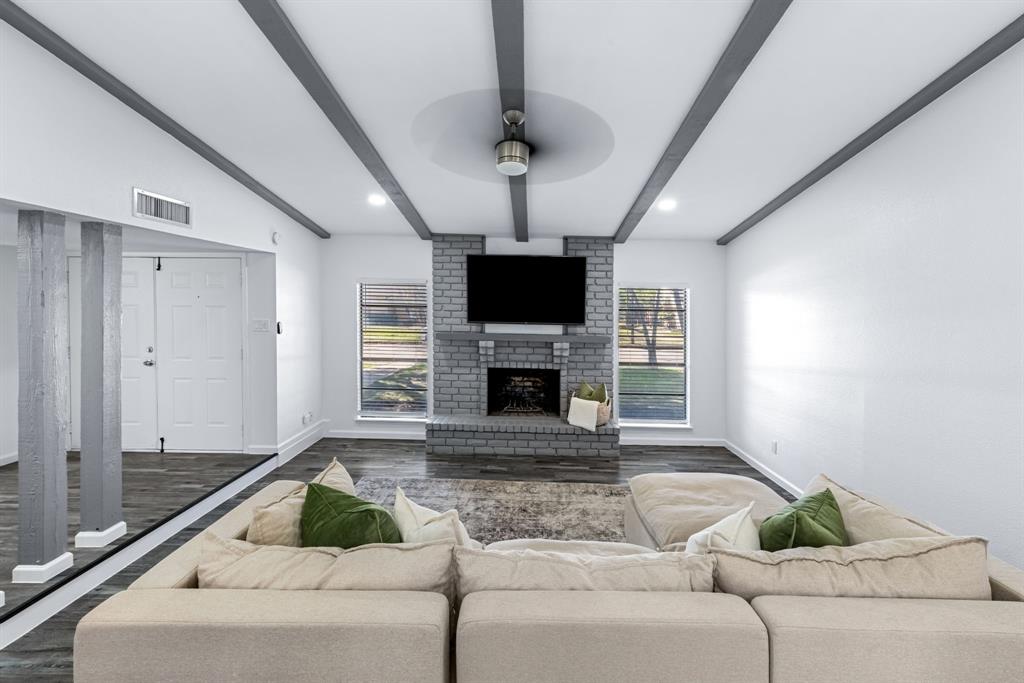 3429 Post Oak Road Garland, TX 75044 - Photo 12 of 36 a living room with furniture and a fireplace