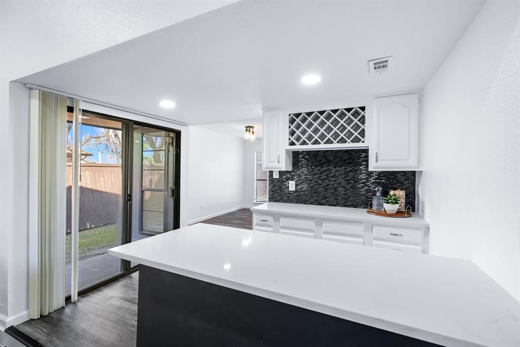 3429 Post Oak Road Garland, TX 75044 - Photo 16 of 36 a kitchen with a sink a large window and a refrigerator