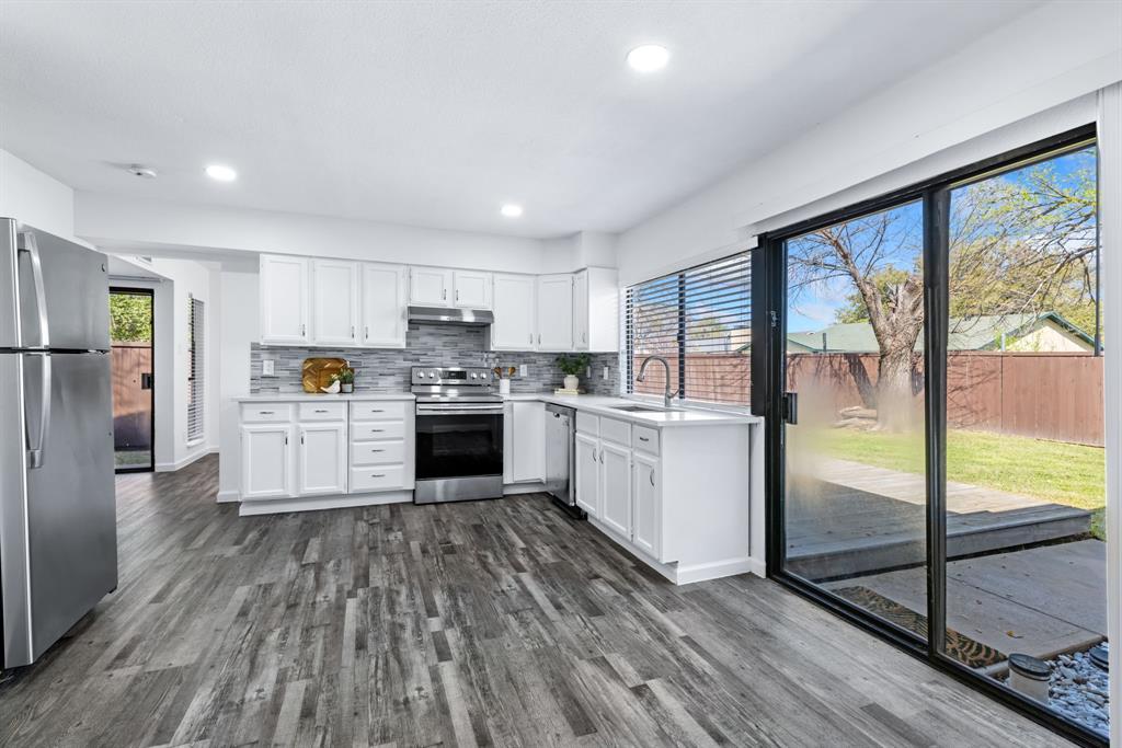 3429 Post Oak Road Garland, TX 75044 - Photo 19 of 36 a kitchen with a refrigerator a sink and cabinets