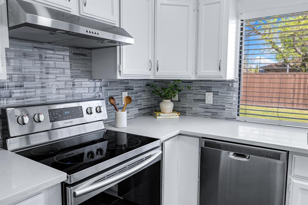 3429 Post Oak Road Garland, TX 75044 - Photo 20 of 36 a kitchen with stainless steel appliances a sink stove and cabinets
