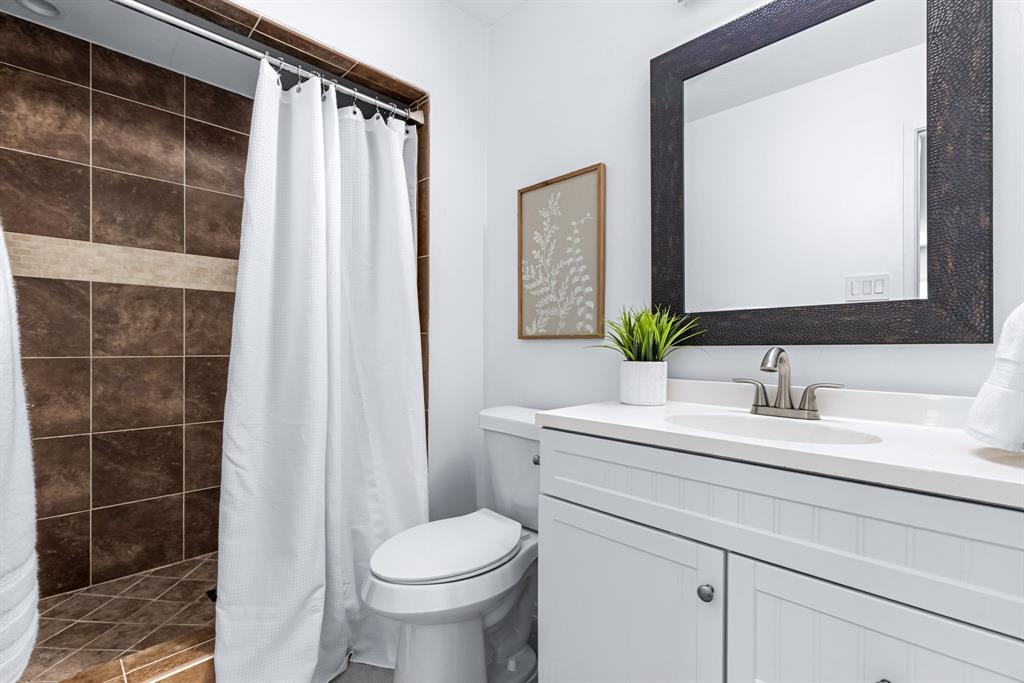 3429 Post Oak Road Garland, TX 75044 - Photo 27 of 36 a bathroom with a granite countertop sink and a mirror