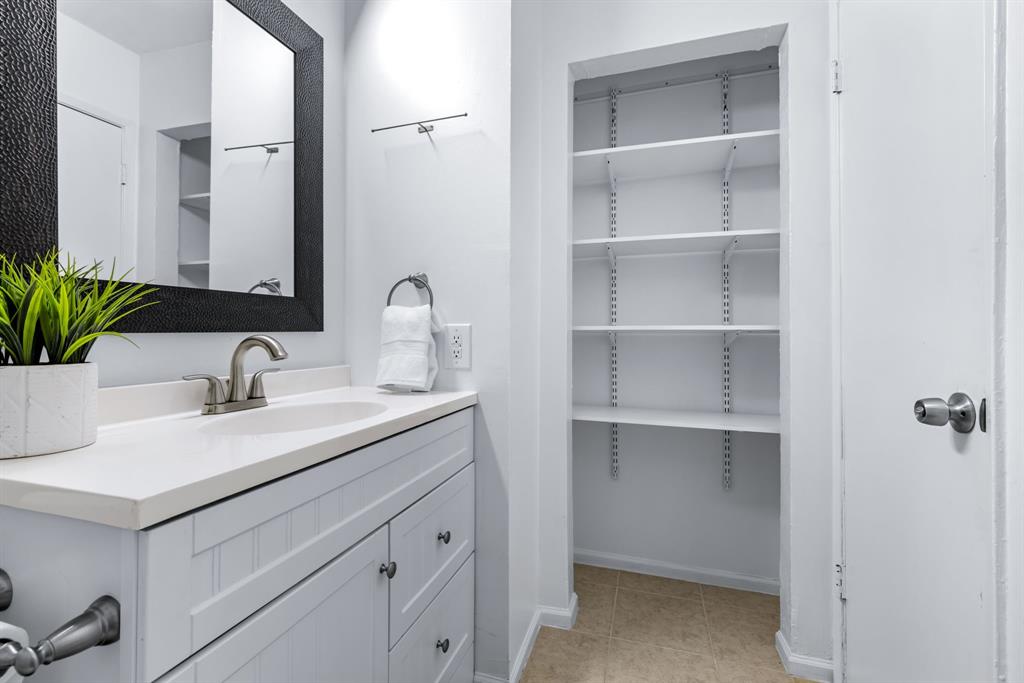 3429 Post Oak Road Garland, TX 75044 - Photo 31 of 36 a bathroom with a sink and a mirror