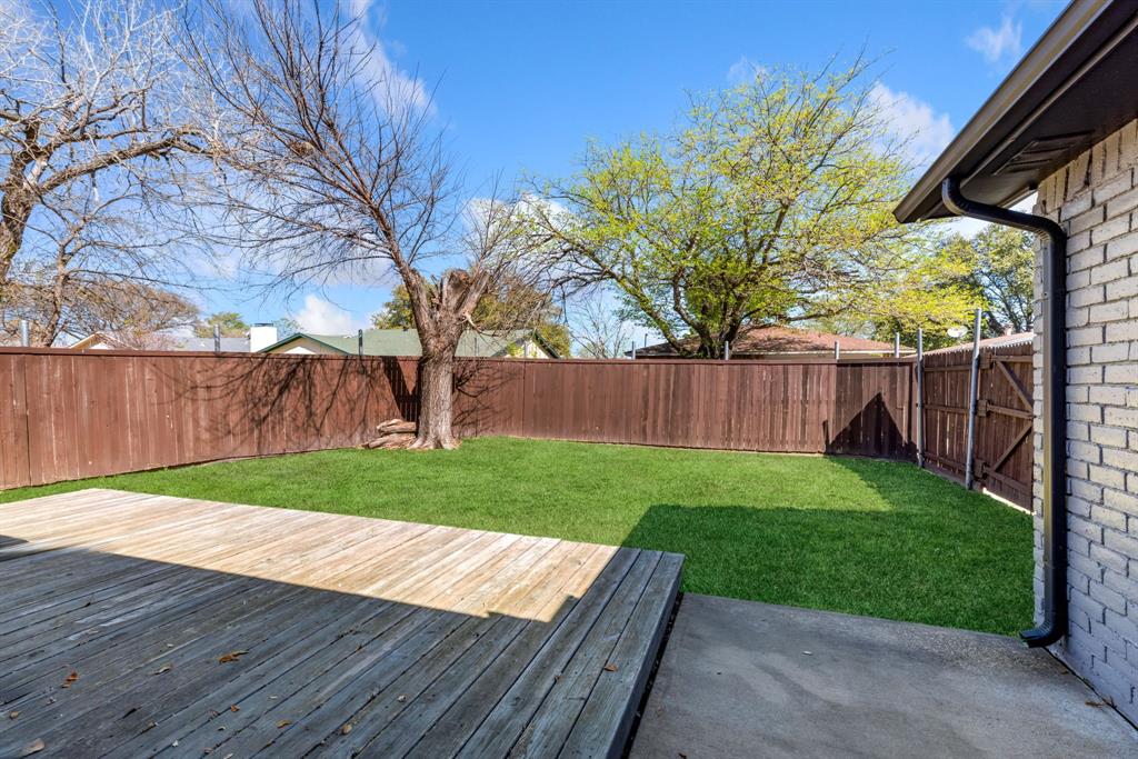 3429 Post Oak Road Garland, TX 75044 - Photo 32 of 36 a view of backyard with wooden fence and large trees