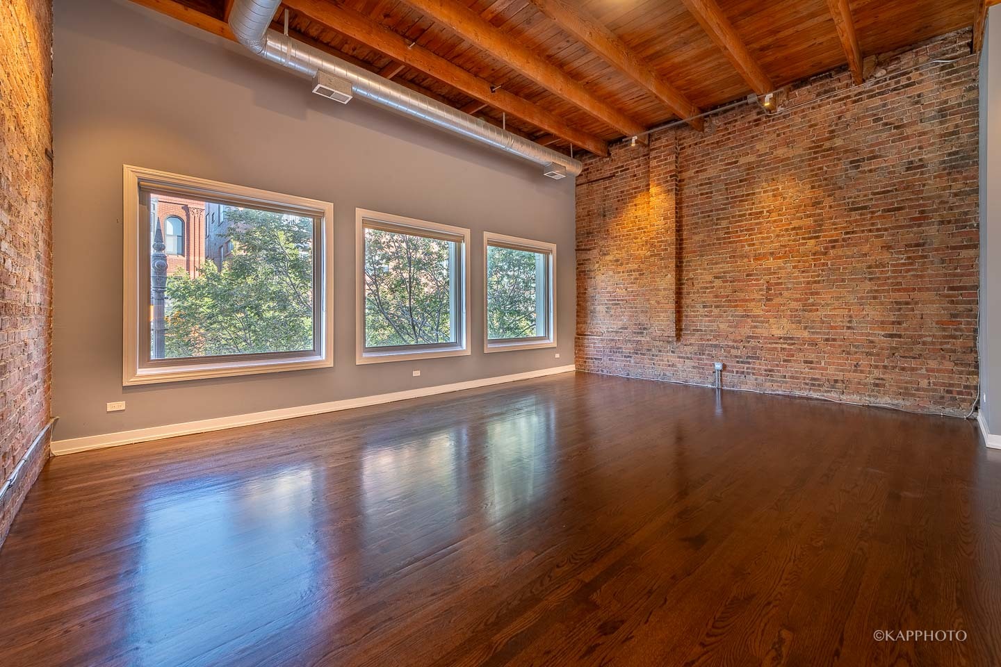 1141 West Madison Street, Unit 3 Chicago, IL 60607 - Photo 11 of 34 a view of an empty room with wooden floor and a window