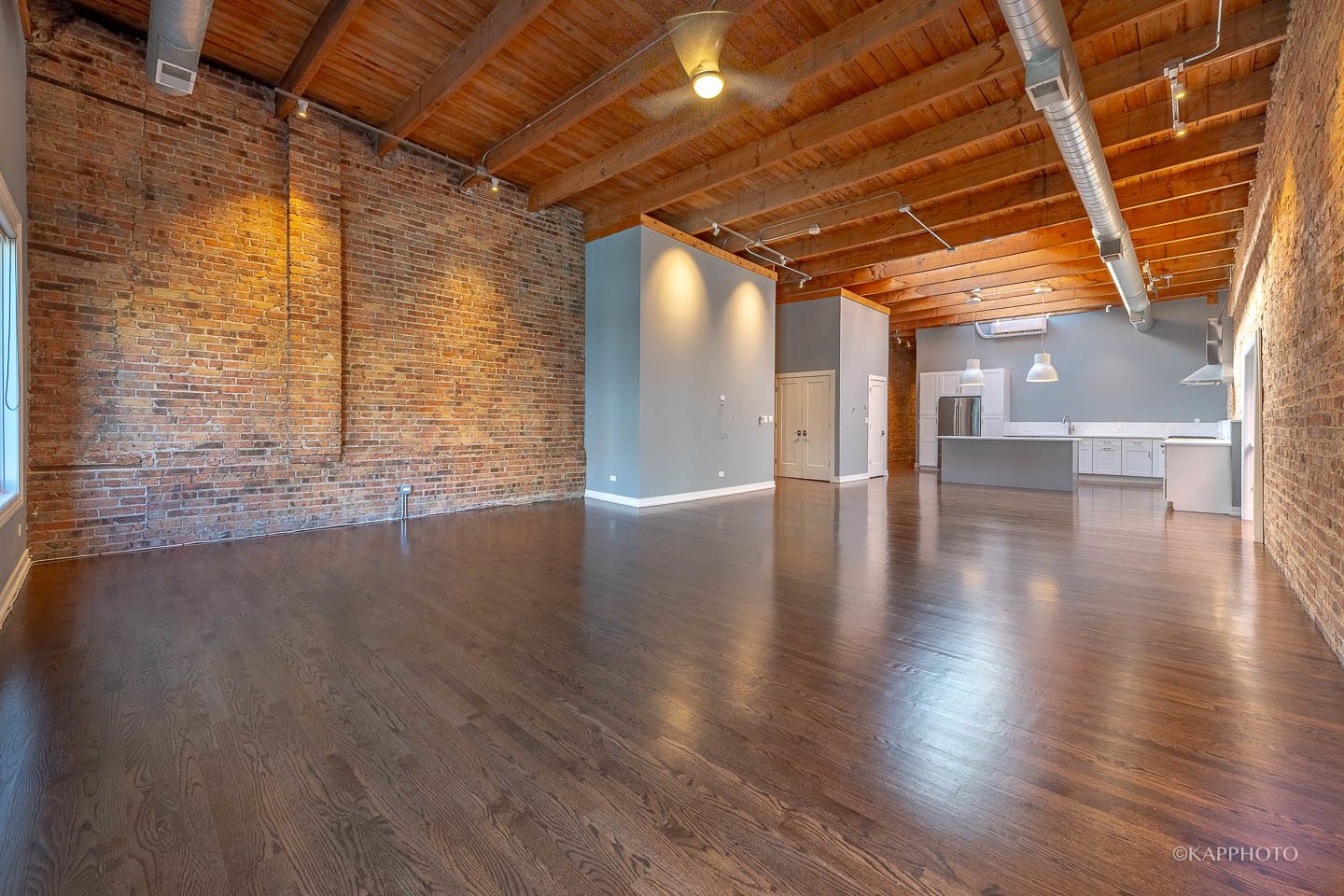 1141 West Madison Street, Unit 3 Chicago, IL 60607 - Photo 12 of 34 a view of an empty room with wooden floor and a window