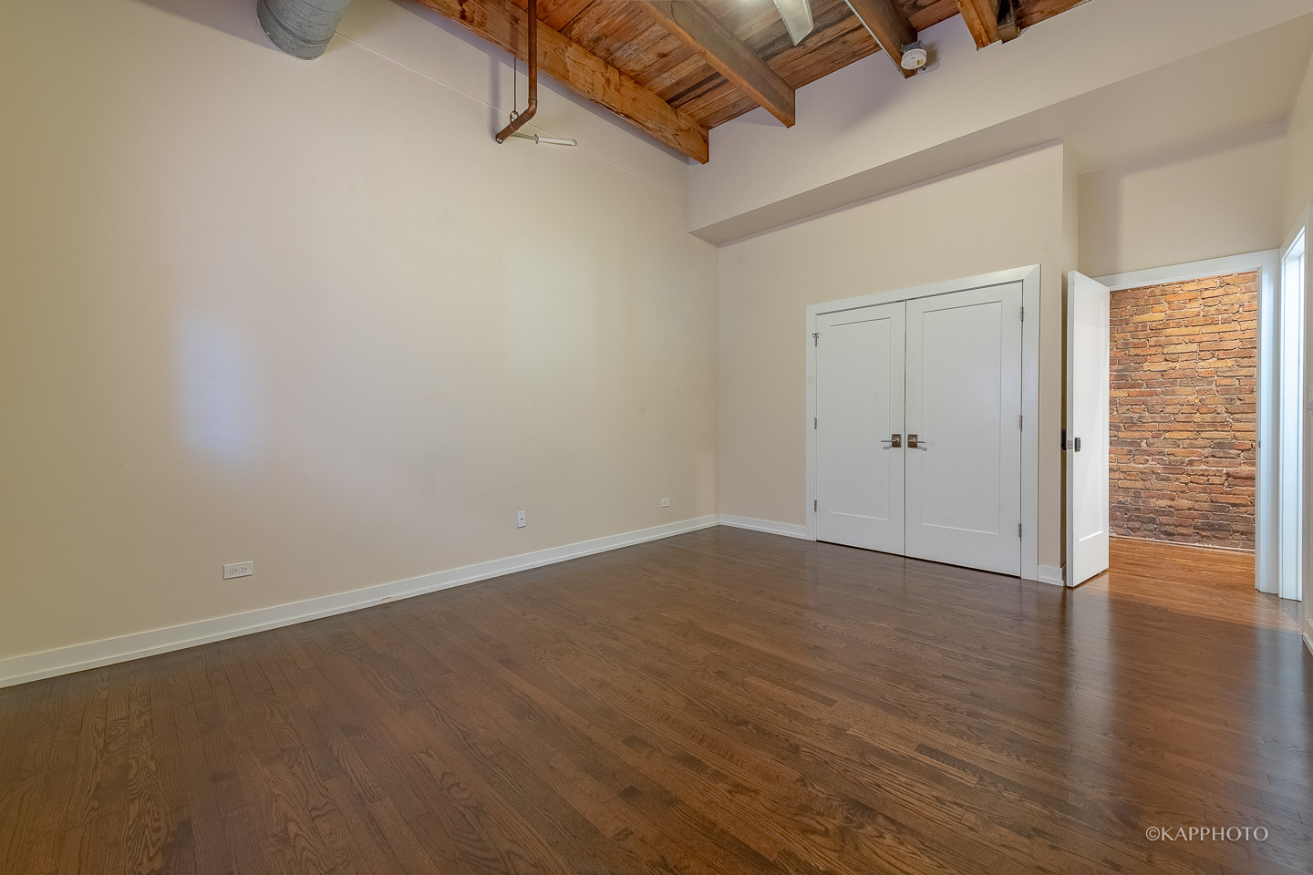 1141 West Madison Street, Unit 3 Chicago, IL 60607 - Photo 18 of 34 a view of an empty room with wooden floor and a window