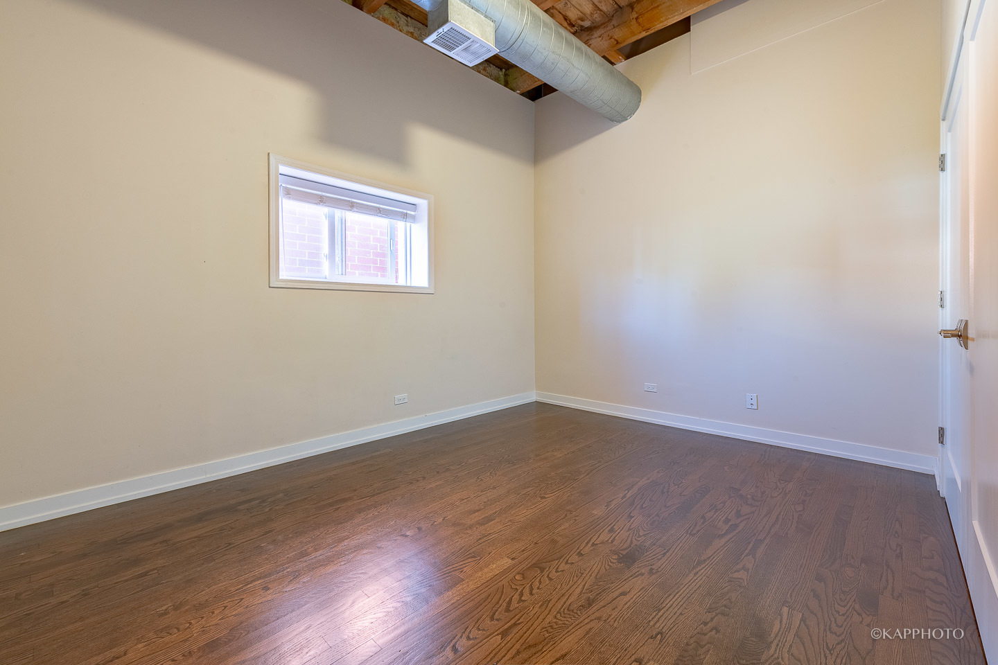 1141 West Madison Street, Unit 3 Chicago, IL 60607 - Photo 20 of 34 an empty room with wooden floor and windows