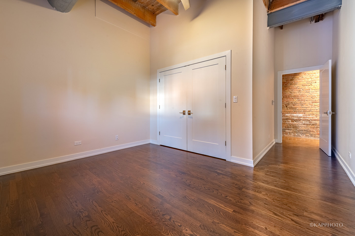 1141 West Madison Street, Unit 3 Chicago, IL 60607 - Photo 21 of 34 a view of an empty room with wooden floor and a window