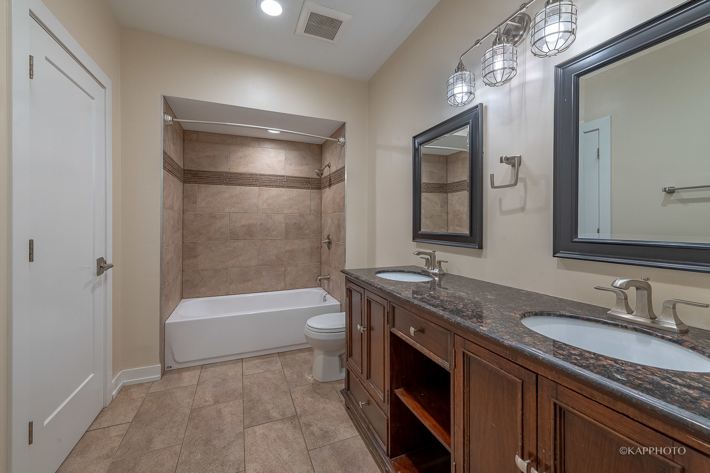 1141 West Madison Street, Unit 3 Chicago, IL 60607 - Photo 22 of 34 a bathroom with a granite countertop sink a mirror a vanity a toilet and bathtub
