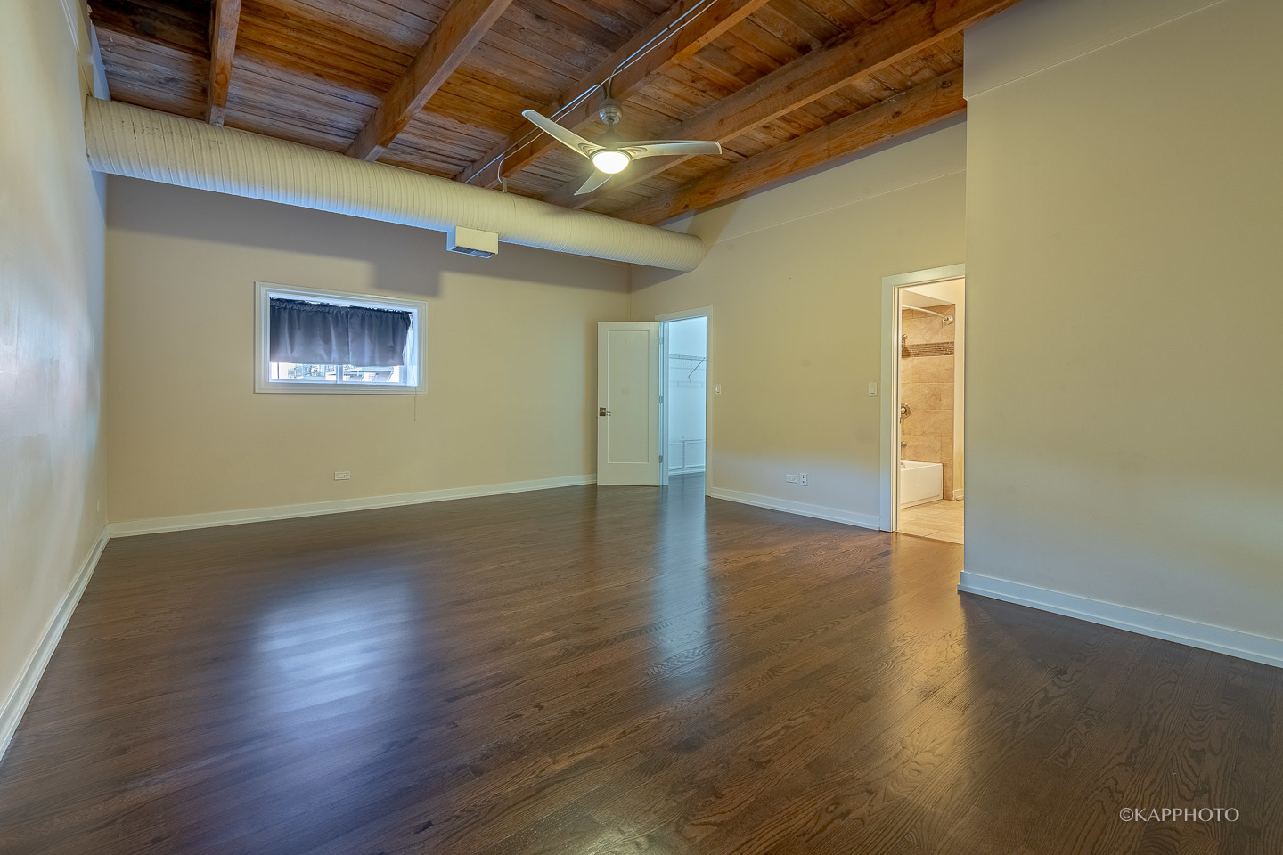 1141 West Madison Street, Unit 3 Chicago, IL 60607 - Photo 26 of 34 an empty room with wooden floor and windows