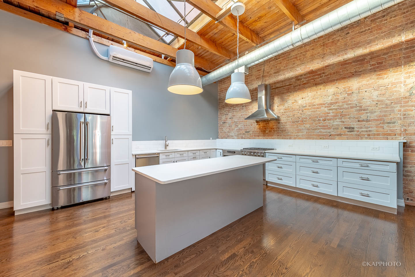 1141 West Madison Street, Unit 3 Chicago, IL 60607 - Photo 4 of 34 a view of a kitchen with a sink a refrigerator and wooden floor