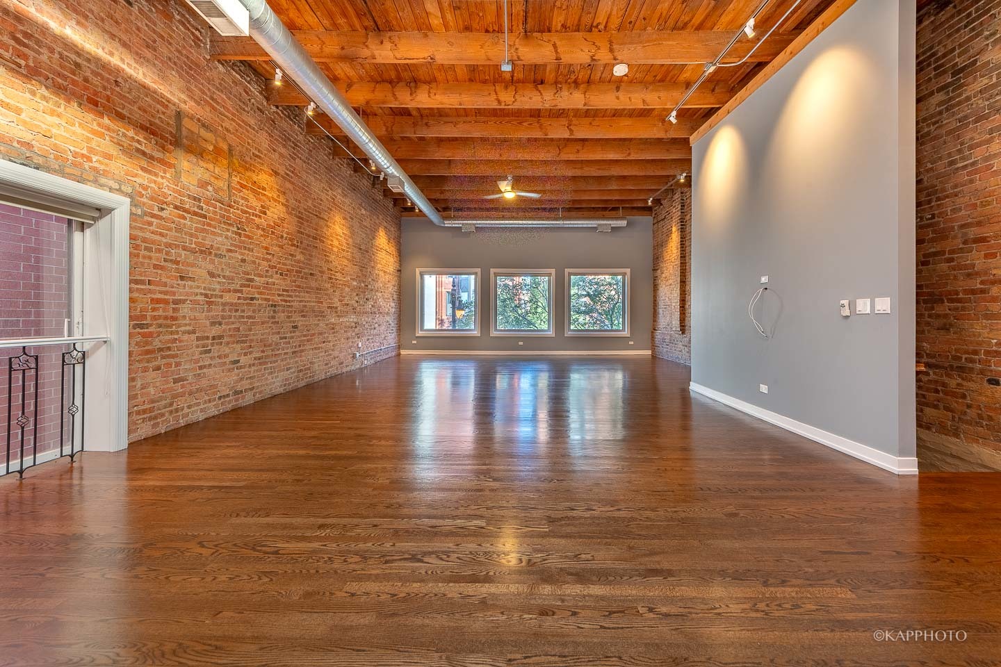 1141 West Madison Street, Unit 3 Chicago, IL 60607 - Photo 9 of 34 a view of an empty room with wooden floor and a window