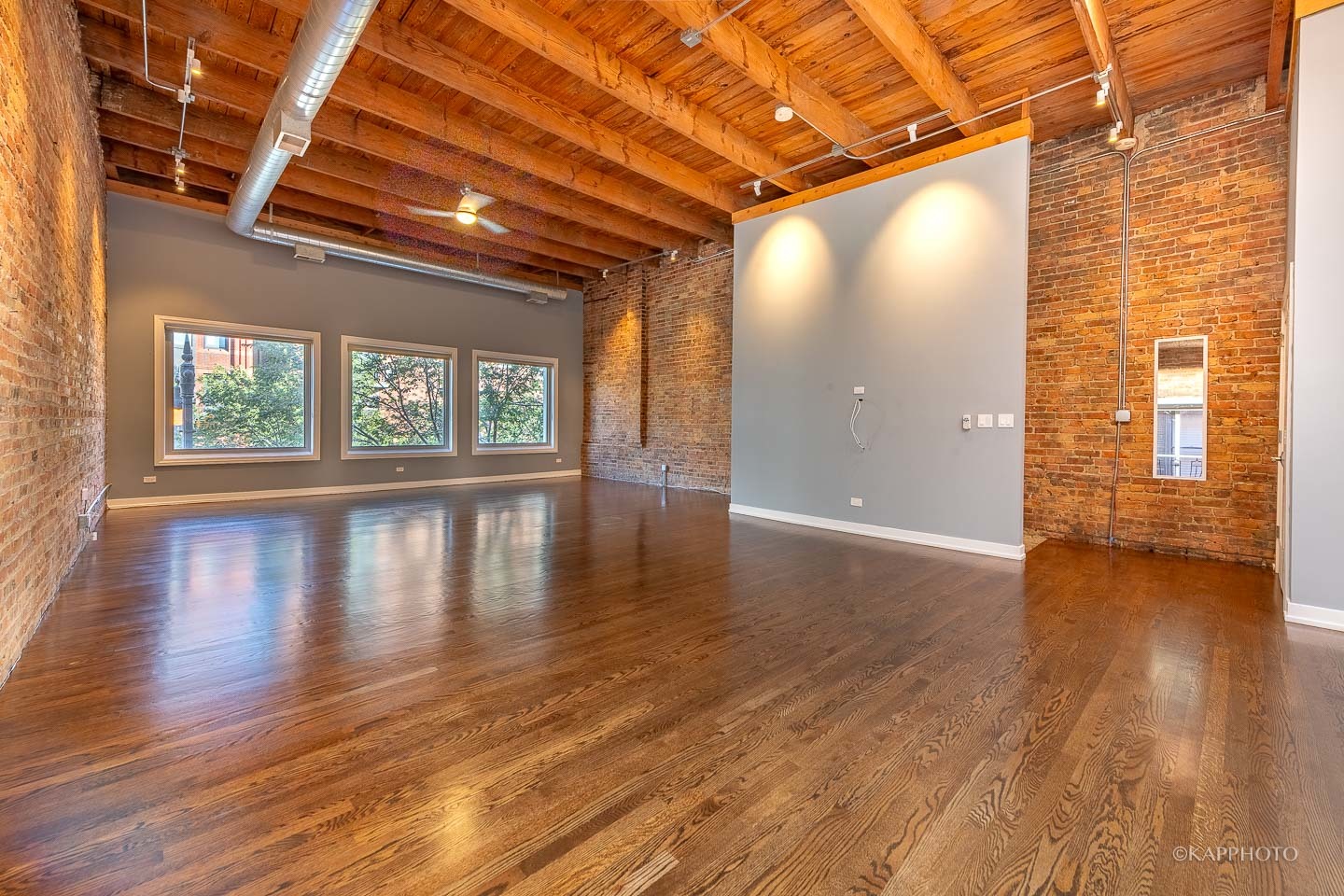 1141 West Madison Street, Unit 3 Chicago, IL 60607 - Photo 10 of 34 a view of an empty room with wooden floor and a window