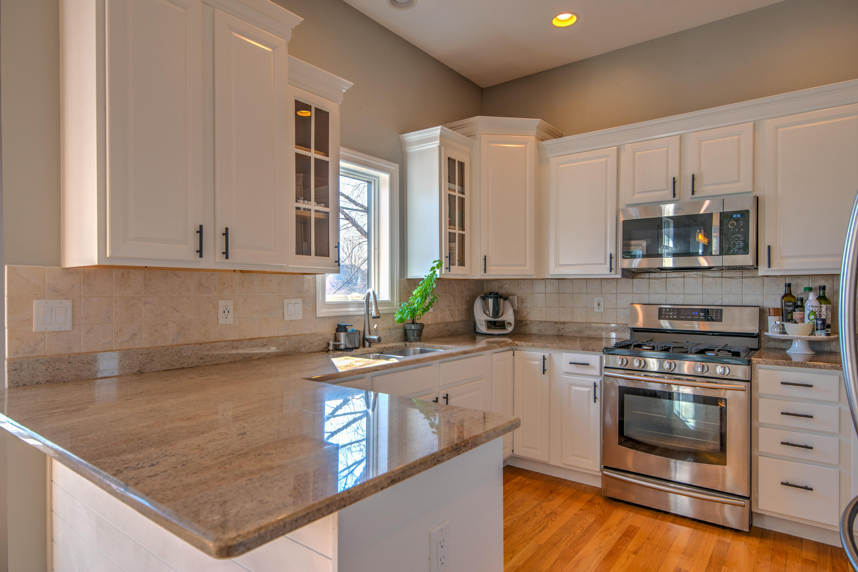 669 Davis Circle Crown Point, IN 46307 - Photo 9 of 22 a kitchen with stainless steel appliances granite countertop a stove a sink and a microwave