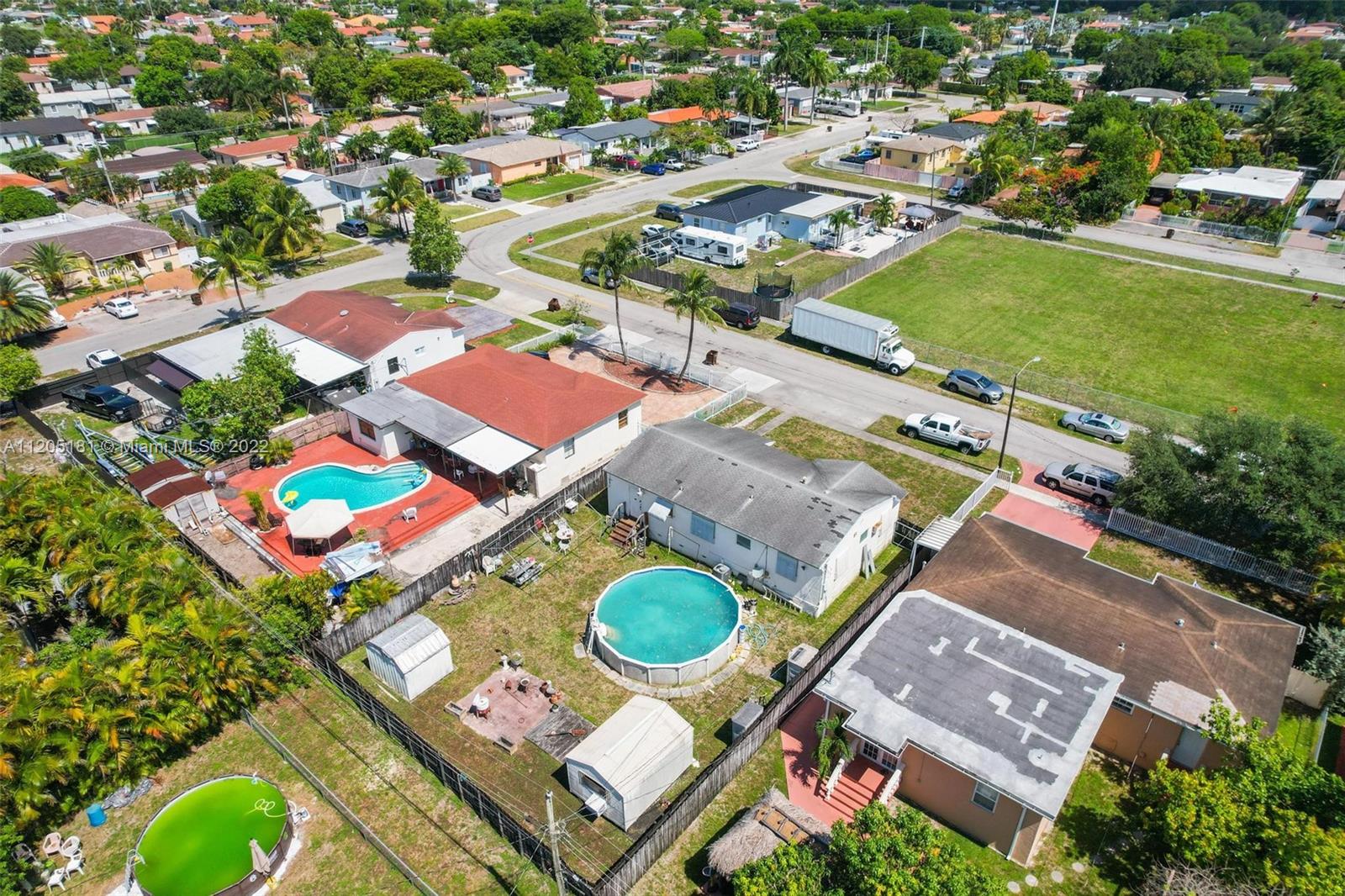 170 West 58th Street Hialeah, FL 33012 - Photo 11 of 12 an aerial view of residential houses with outdoor space and parking