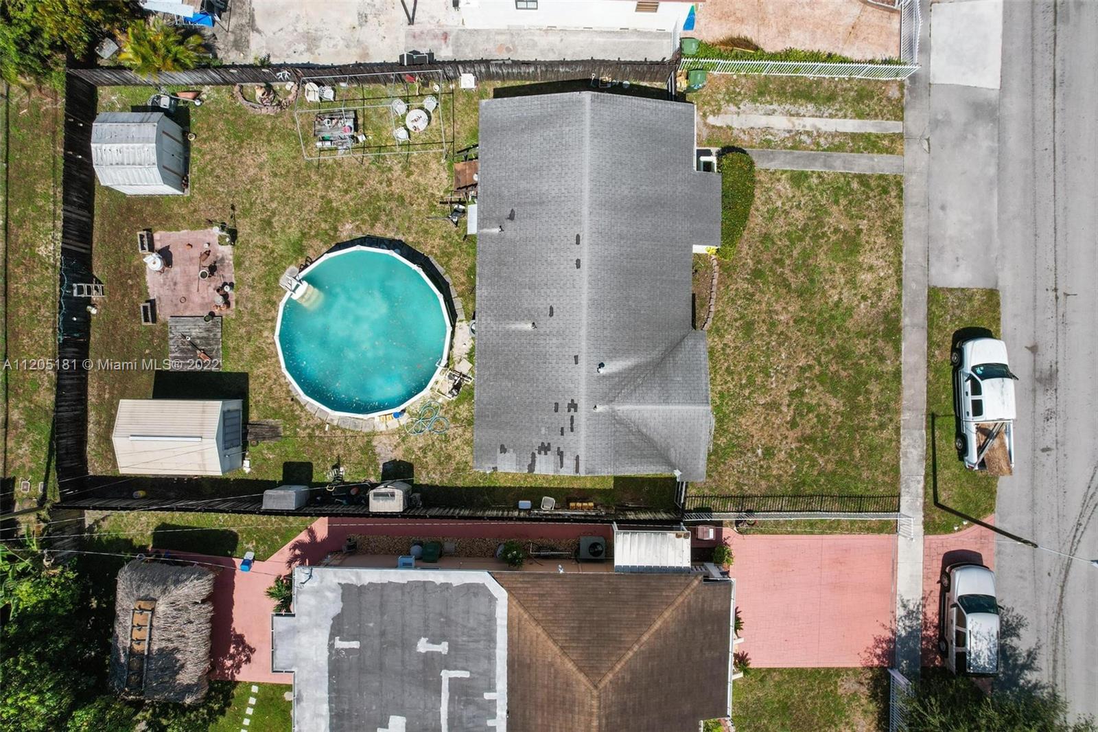 170 West 58th Street Hialeah, FL 33012 - Photo 12 of 12 an aerial view of a house with a swimming pool and outdoor seating