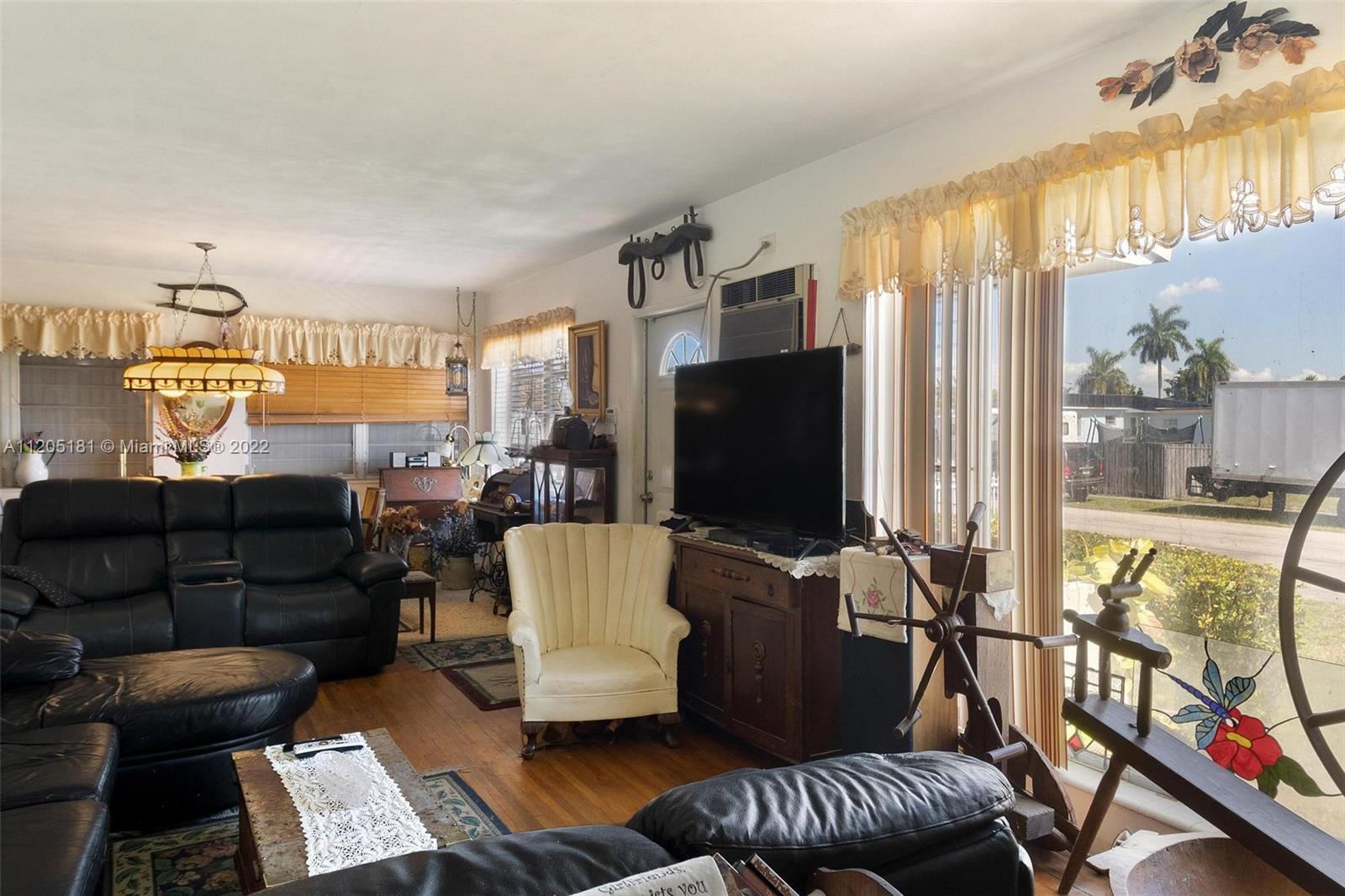 170 West 58th Street Hialeah, FL 33012 - Photo 3 of 12 a living room with furniture and a flat screen tv