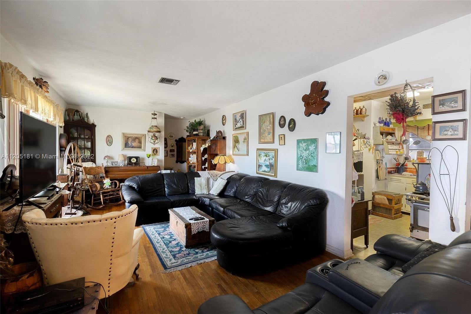 170 West 58th Street Hialeah, FL 33012 - Photo 4 of 12 a living room with furniture and a flat screen tv