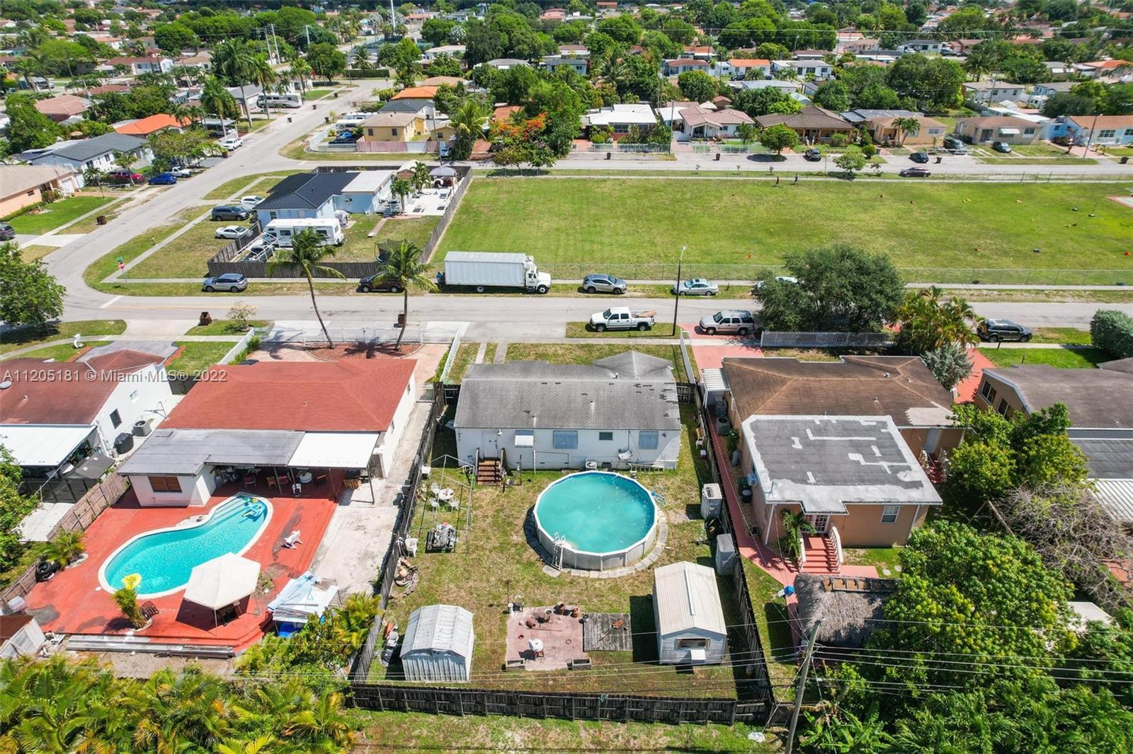 170 West 58th Street Hialeah, FL 33012 - Photo 10 of 12 an aerial view of residential houses with outdoor space and swimming pool