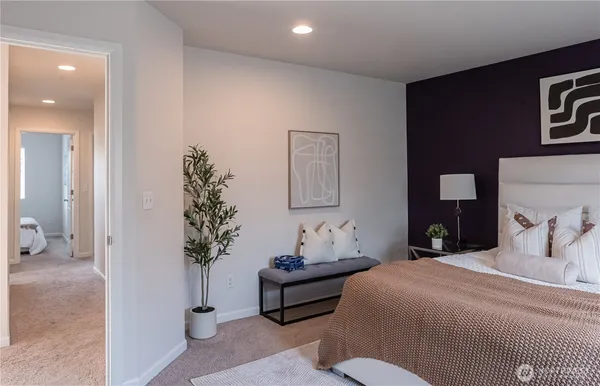 a bedroom with a bed and a potted plant