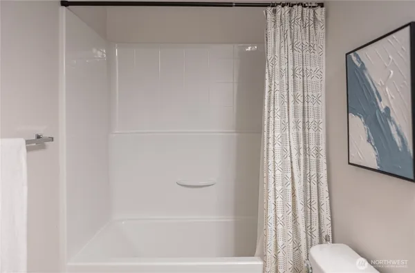 a bathroom with a shower curtain and a toilet