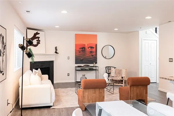 a living room with furniture a fireplace and white walls