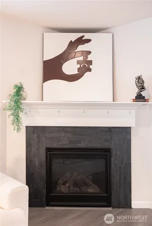 a living room with a fireplace and wooden floor