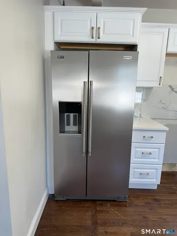 a view of storage and utility room with wooden floor